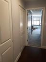 Corridor featuring baseboards and dark wood-style flooring