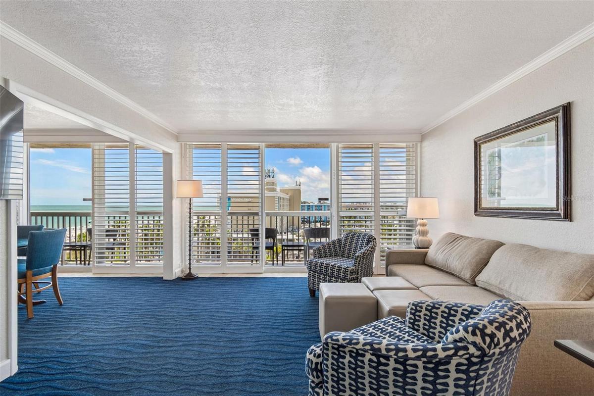 Enter to a living area with wall to wall sliders to balcony & water & resort views. Sleeper sofa to accommodate up to 8 guests