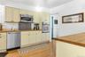 Kitchen with stainless steel appliances, butcher block countertops, and light wood-type flooring