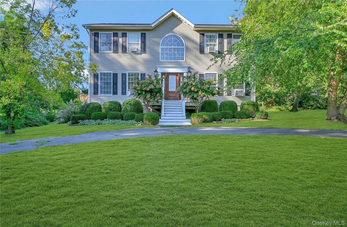 Colonial inspired home with a front lawn