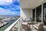 From your private balcony, take in the sights of passing boats, lush waterfront residences, and the stunning skyline beyond—all while basking in the w