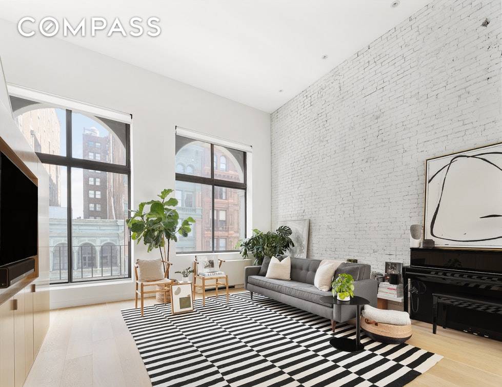 MODERN MEETS CLASSIC. Light pours in from a wall of huge arched windows framing architectural views in this prewar one bedroom duplex loft with exposed brick, high ceilings which soar ...