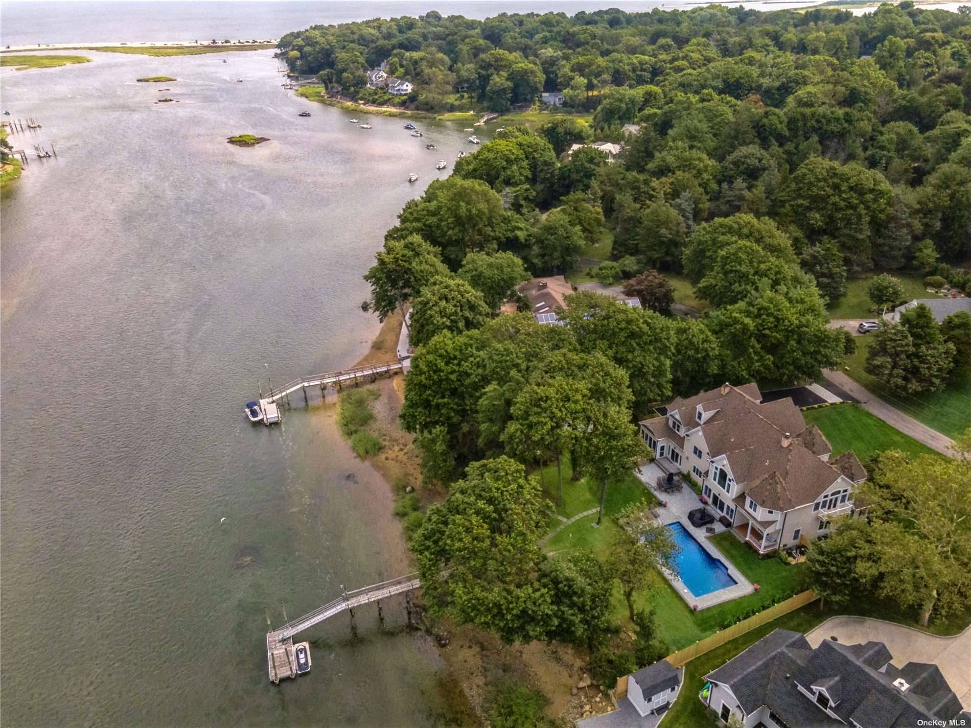Nestled in the heart of historic Setauket, this Hamptons style residence offers an unparalleled waterfront living experience.