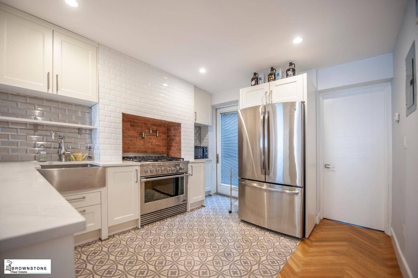 This cutting edge three family townhouse is currently configured as a sophisticated owners duplex plus two high end two bedroom floor throughs.