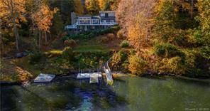 Nestled along 140 feet of pristine Candlewood Lake shoreline in the sought after Deer Run Shores community, this residence offers an exquisite lakeside retreat.