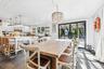 Dining room with dark wood-style flooring, french doors, and a chandelier