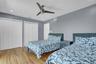 Bedroom 4 with wood finished floors, two closets, ceiling fan, and recessed lighting