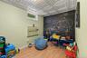 Room featuring wood-finish flooring, a decorative ceiling with square panels, and a chalkboard wall