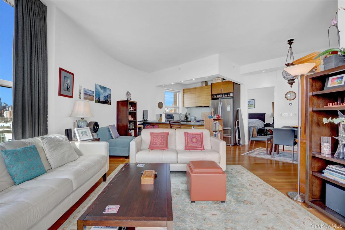 Living room with light wood-style floors and a desk