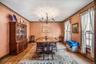 Dining area with hardwood / wood-style floors, a chandelier, and ornamental molding