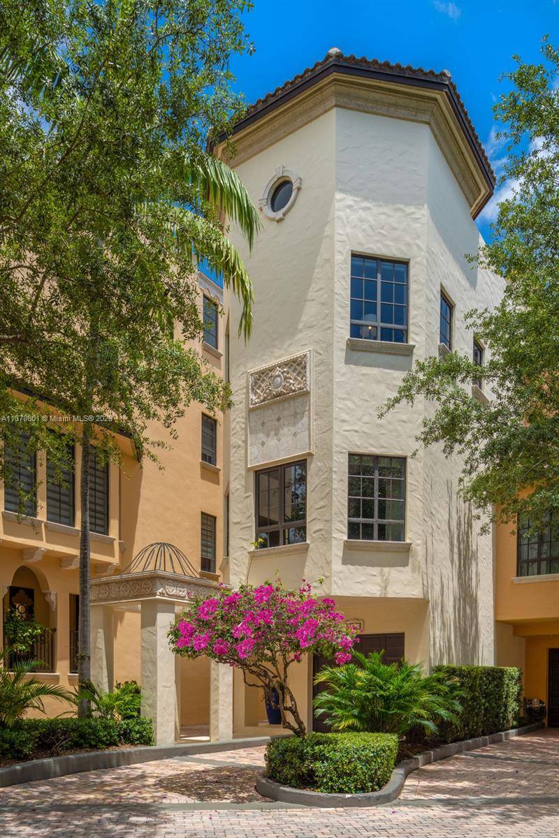 Located in the coveted gated enclave of Cloisters on the Bay, in the heart of Coconut Grove, this charming three story plus rooftop terrace villa has 4 BD, 4.