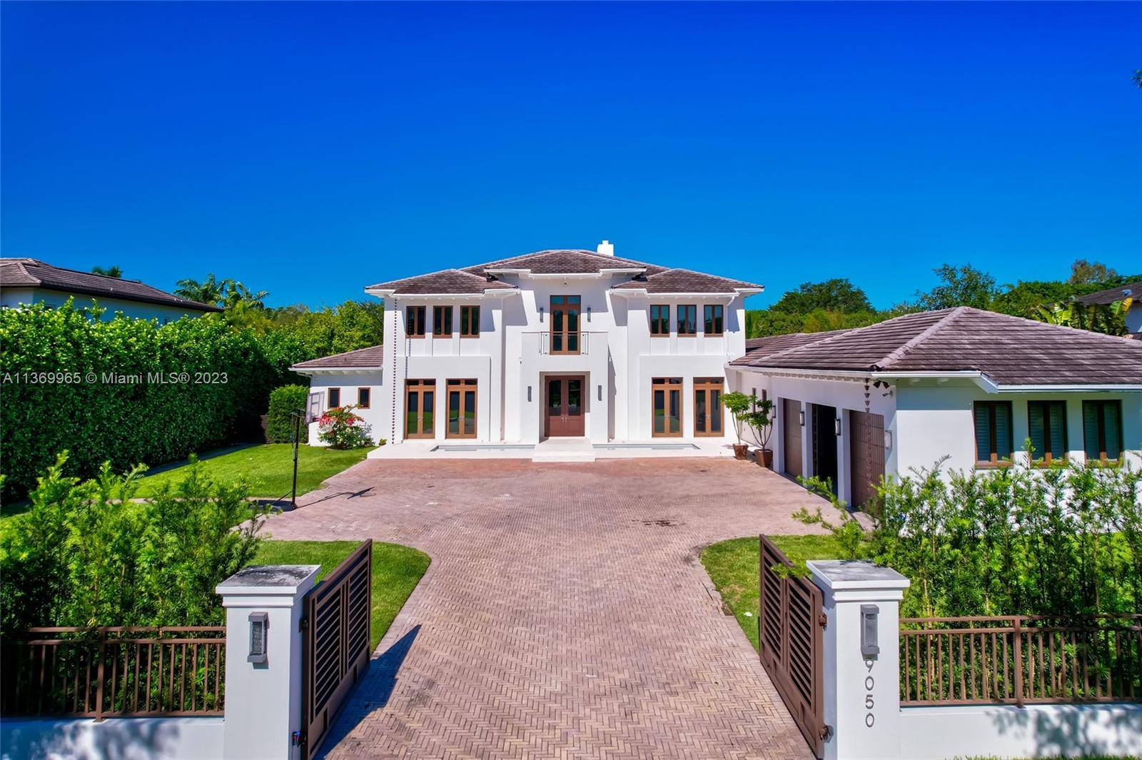 Located in exclusive beautiful Stritter Estates of Pinecrest, this gated smart home features a 2 story dramatic entry foyer w views to the open floor plan pool spa area.