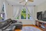 Bright living space featuring natural light from multiple windows and wood-finish flooring