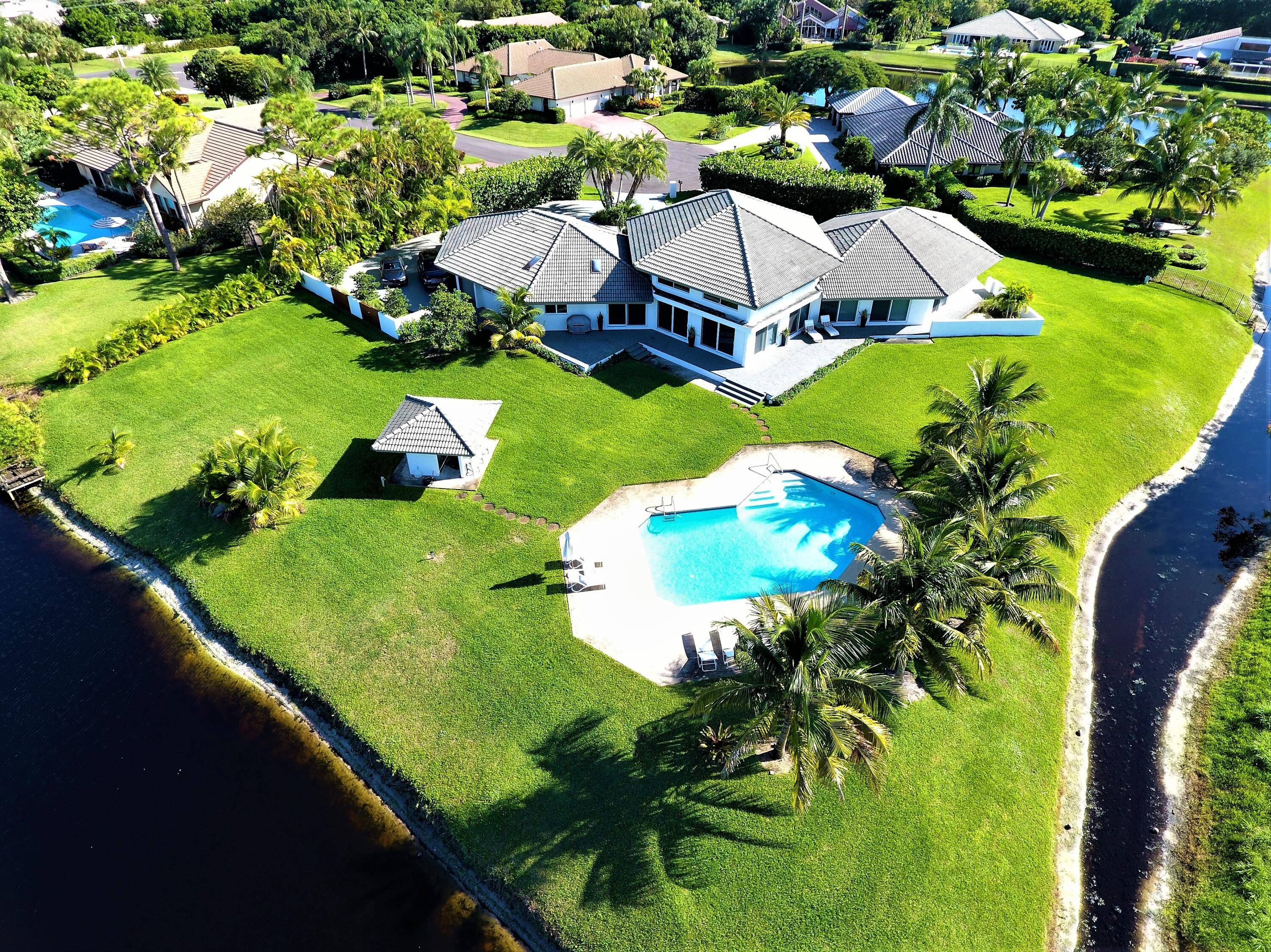 Contemporary private estate spanning 5, 375 sqft nestled amidst the lakes and meandering fairways of the Seagate Country Club.