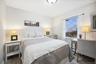 Bedroom featuring wood finished floors and a baseboard radiator