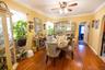Dining area with wood-type flooring, ceiling fan, plenty of natural light, arched walkways, and ornamental molding