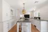Custom Cabinetry, Nantucket style beadboard wide planked paneling and paneled covered appliances.