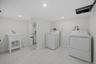 Laundry room featuring washing machine and dryer and recessed lighting