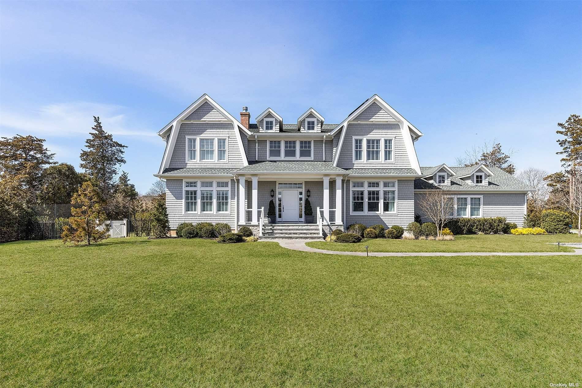 Located in the highly desirable estate section of Quogue Village, this elegant residence blends classic Hamptons style with modern functionality and amenities.
