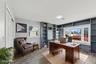 Dedicated room featuring extensive built-in shelving, a prominent bay window, recessed lighting, and wood-finish flooring