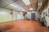 Below grade area featuring a heating unit, a drop ceiling, and tile patterned flooring