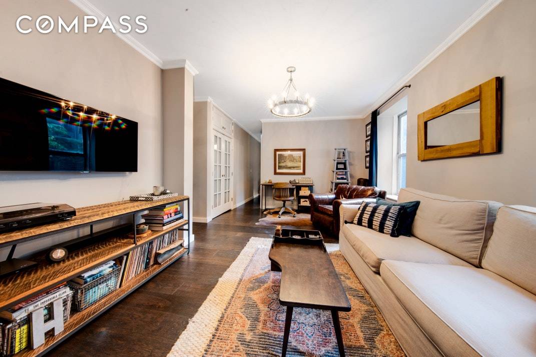 This sunny West Village one bedroom with windowed home office is a junior four with great light from oversized windows in every room and charming townhouse garden views.