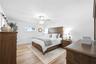large primary retreat tastefully decorated with upgraded lighting and ensuite bathroom