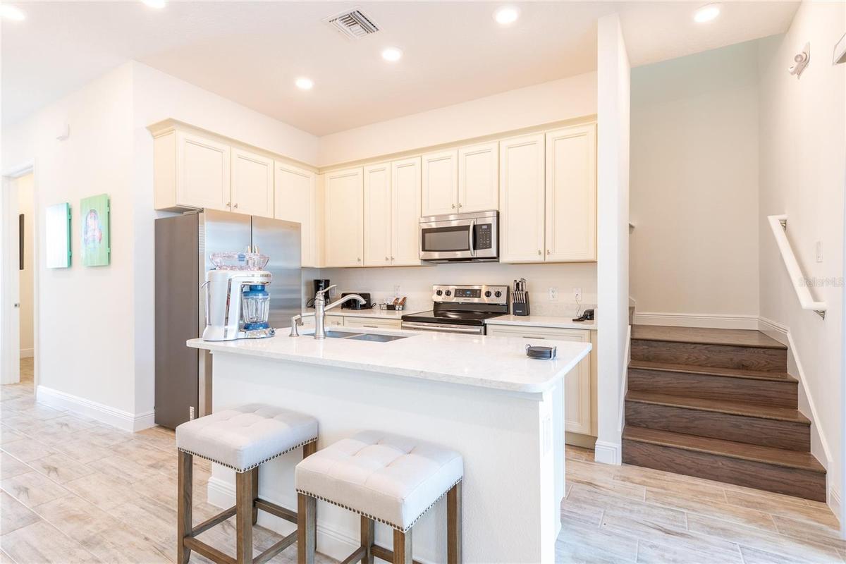 Modern kitchen with large island and open layout in Kissimmee Florida resort style home