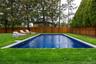 View of swimming pool with a fenced backyard and a patio