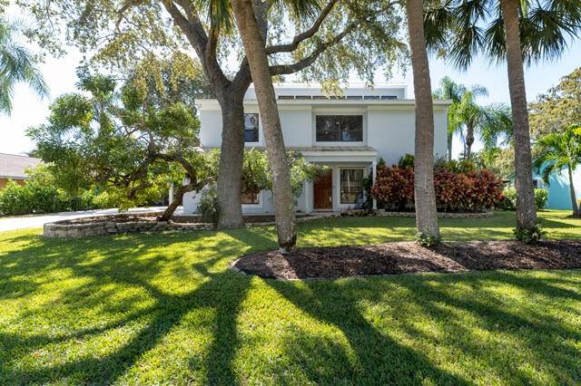 Nestled in Palm Beach Gardens, this Key West style residence is a tranquil retreat with voluminous ceilings, mature Oaks, and a deep water dock with a 16, 000lb lift.