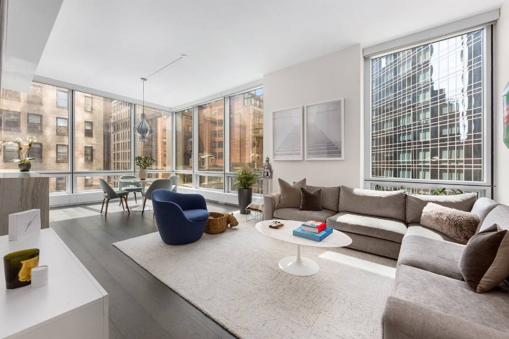 Expansive living space with 11 foot ceilings and floor to ceiling windows throughout.