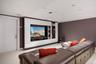 Home theater room featuring light carpet, a tray ceiling, recessed lighting, and ornamental molding