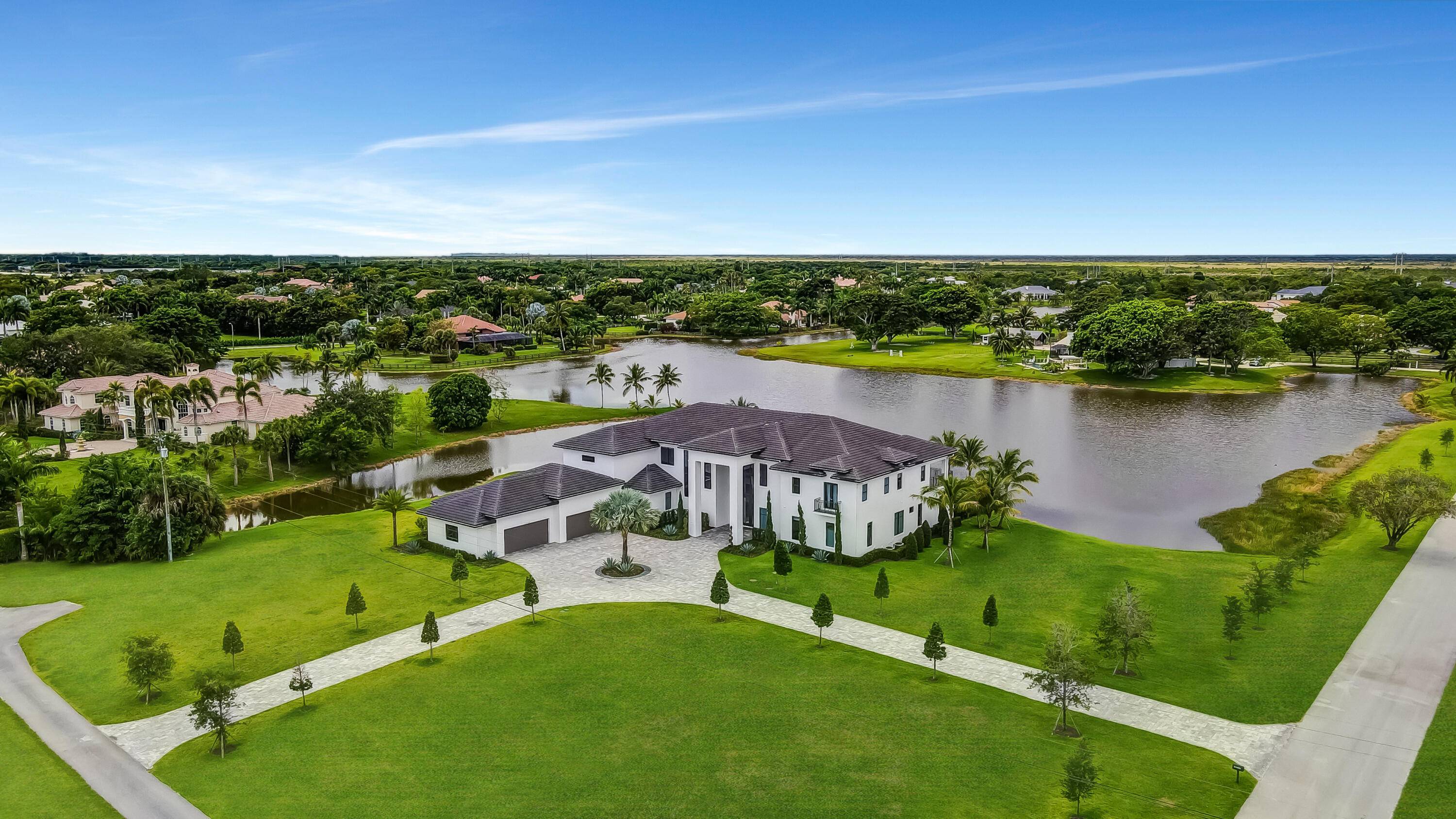 NEW CUSTOM FURNISHED LUXURY ESTATE SITUATED ON 2 ACRES OF LAND WITH ONE OF THE BEST LAKE FRONT LOTS IN ALL OF SOUTH FLORIDA WITH BREATHTAKING VIEWS.