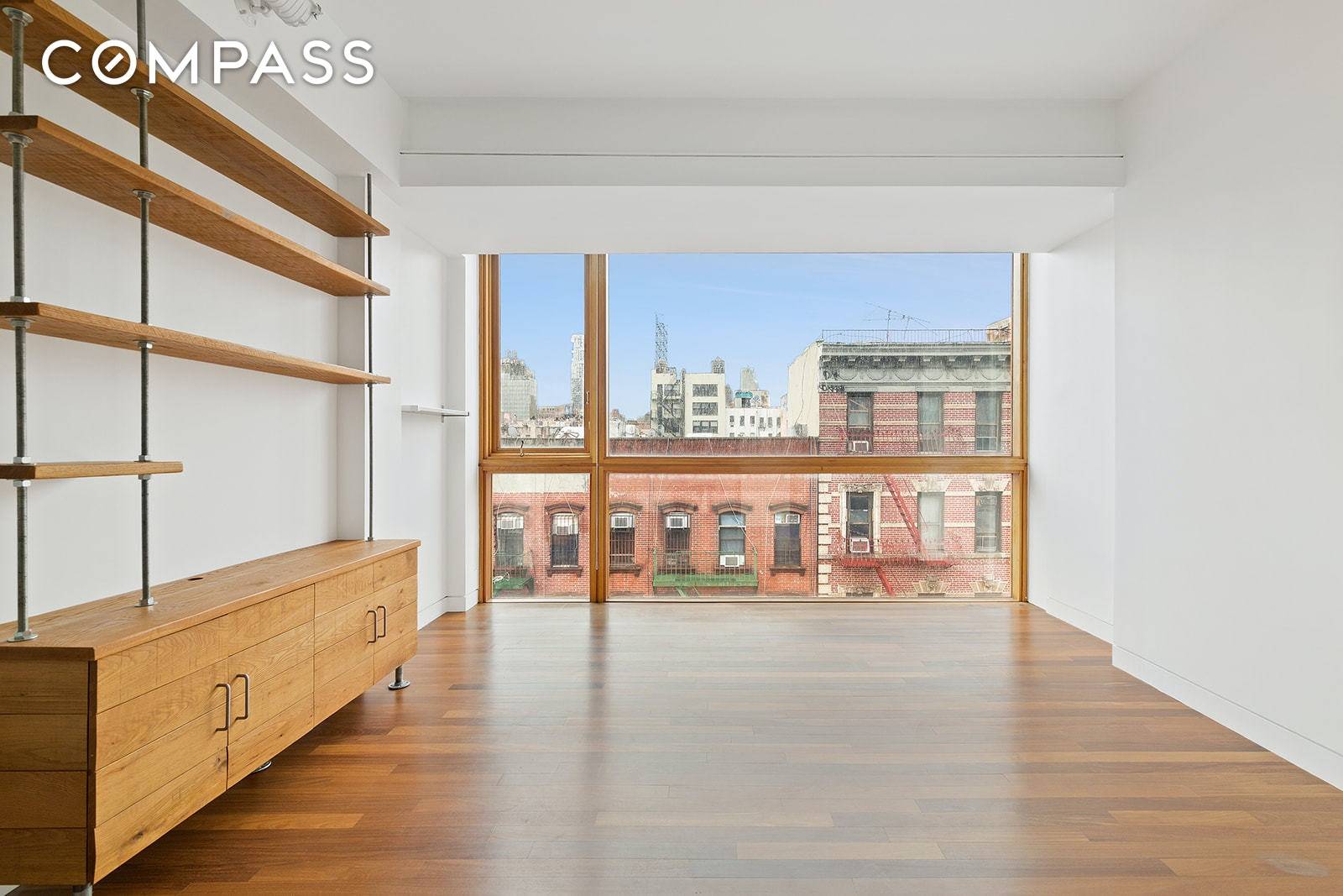 Floor to ceiling windows with beautiful western city views allows gorgeous sunlight to fill this unique 1 BR 1 BA in an intimate 9 unit Lower East Side elevator building.