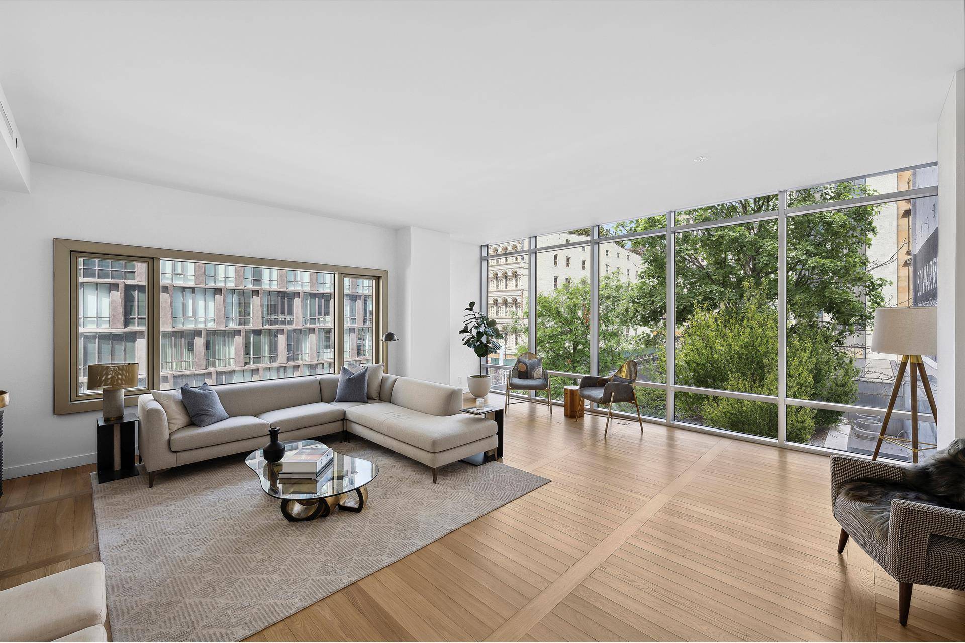 Enjoy the quintessential downtown lifestyle in a luxurious Tribeca condo, featuring views of the city skyline and lush greenery.