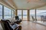 A light-filled corner retreat with panoramic ocean views through wraparound windows. This flexible space is perfect for morning coffee, reading, or en