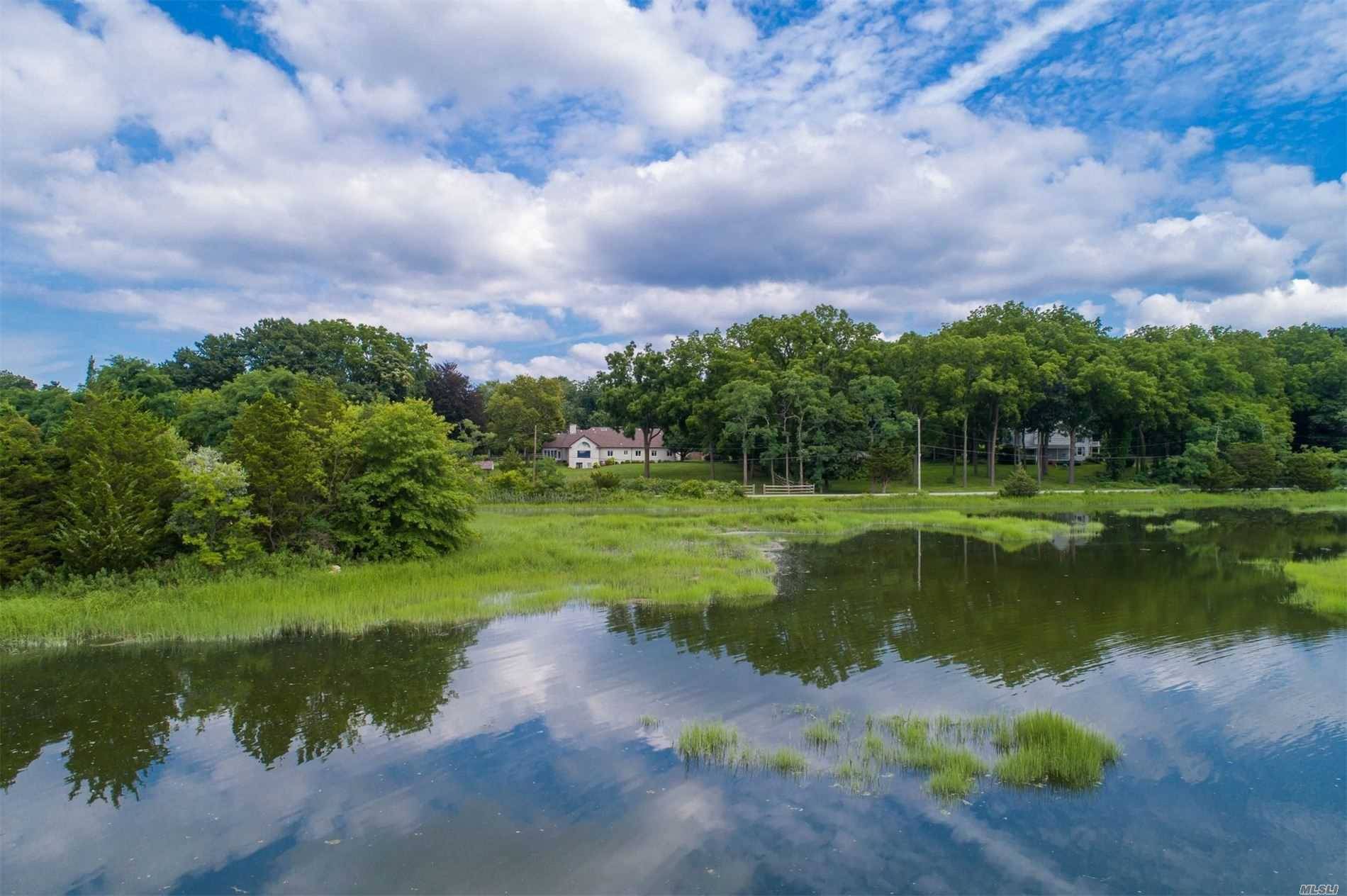 Commanding views over Oyster Bay Harbor in this beautiful European farm ranch in the prestigious village of Cove Neck.