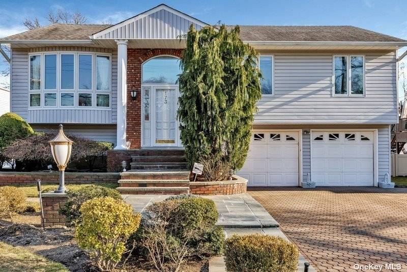Step into this meticulously well maintained, bright and spacious high ranch in the heart of Manhasset Hills.