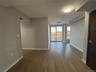 Spare room with dark wood-type flooring and baseboards