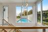 View of swimming pool with a chandelier