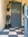 Property entrance featuring stucco siding