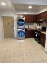 Kitchen with backsplash, black range with gas stovetop, light tile patterned floors, dark brown cabinets, and recessed lighting