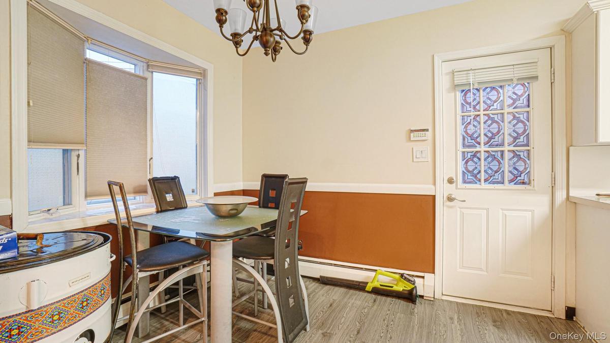 Dining space featuring an inviting chandelier, wood finished floors, and plenty of natural light