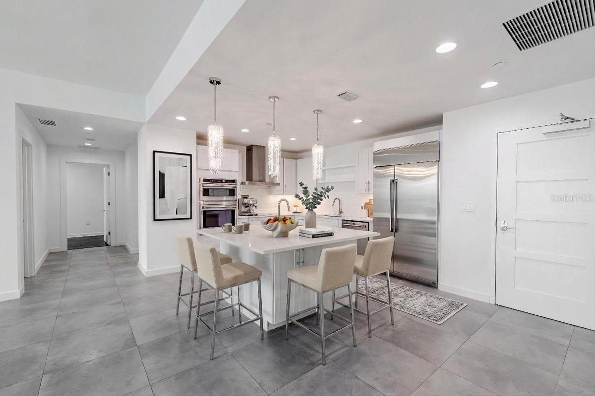 This show stopping modern kitchen is the centerpiece of the home, designed for both style and functionality. A sleek quartz island with storage and si