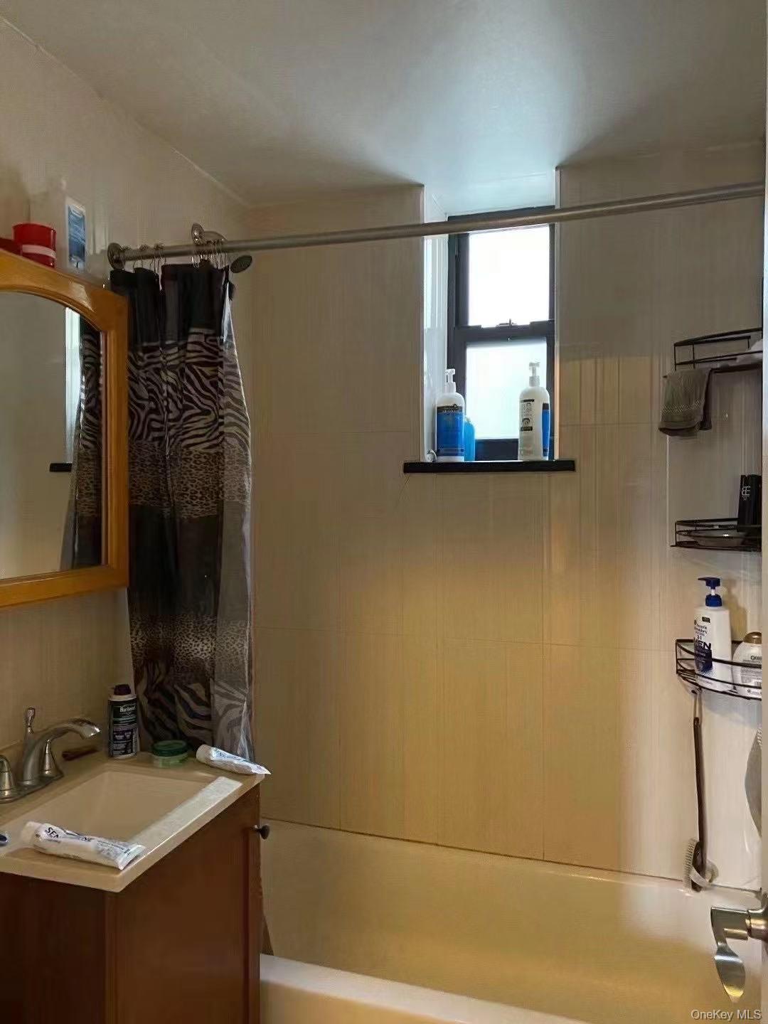 Full bath featuring shower / bathtub combination with curtain and vanity