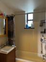 Full bath featuring shower / bathtub combination with curtain and vanity