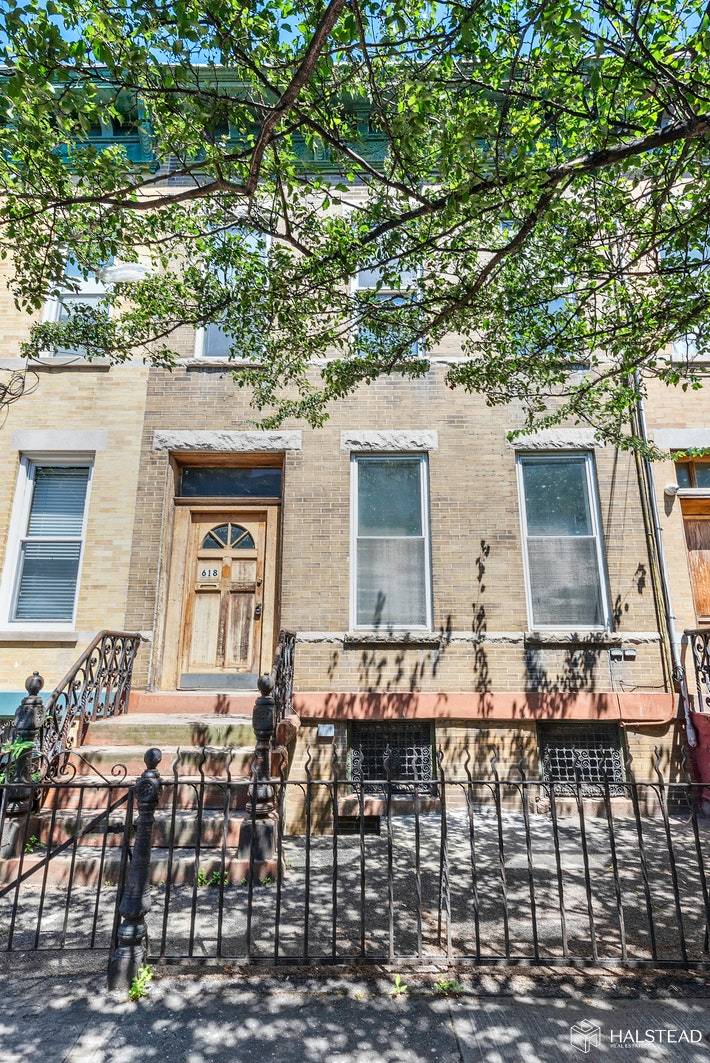 Greenpoint federal style two family with large back yard, original cornice and brick facade.