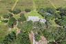 Aerial view of the residence, detached garage & irrigated fields.