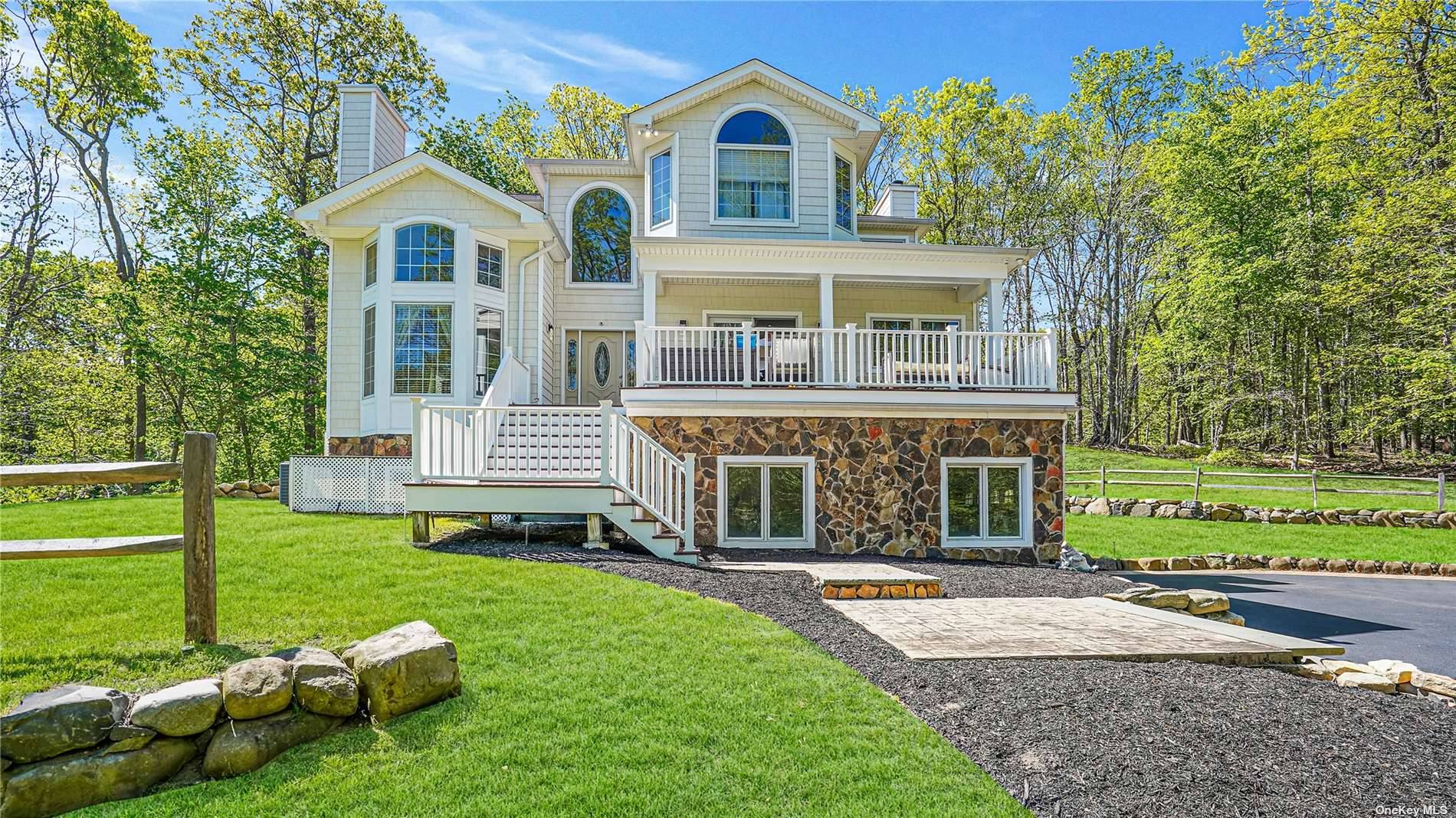 Secluded upon an acre of property, high above the tree tops in the heart of Wading River is this spectacular custom built diamond postmodern home.