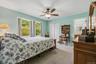 Just off the living room the primary bedroom features morning sunshine and private en suite bath